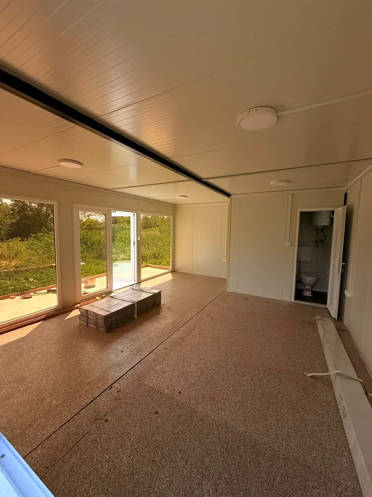 Interno di una tiny house con grandi vetrate